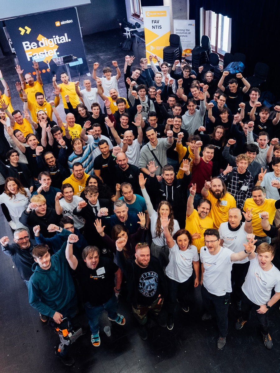 Portrait photograph from AimtecHackathon 2026 showing teams at work as the hackathon timer reaches zero